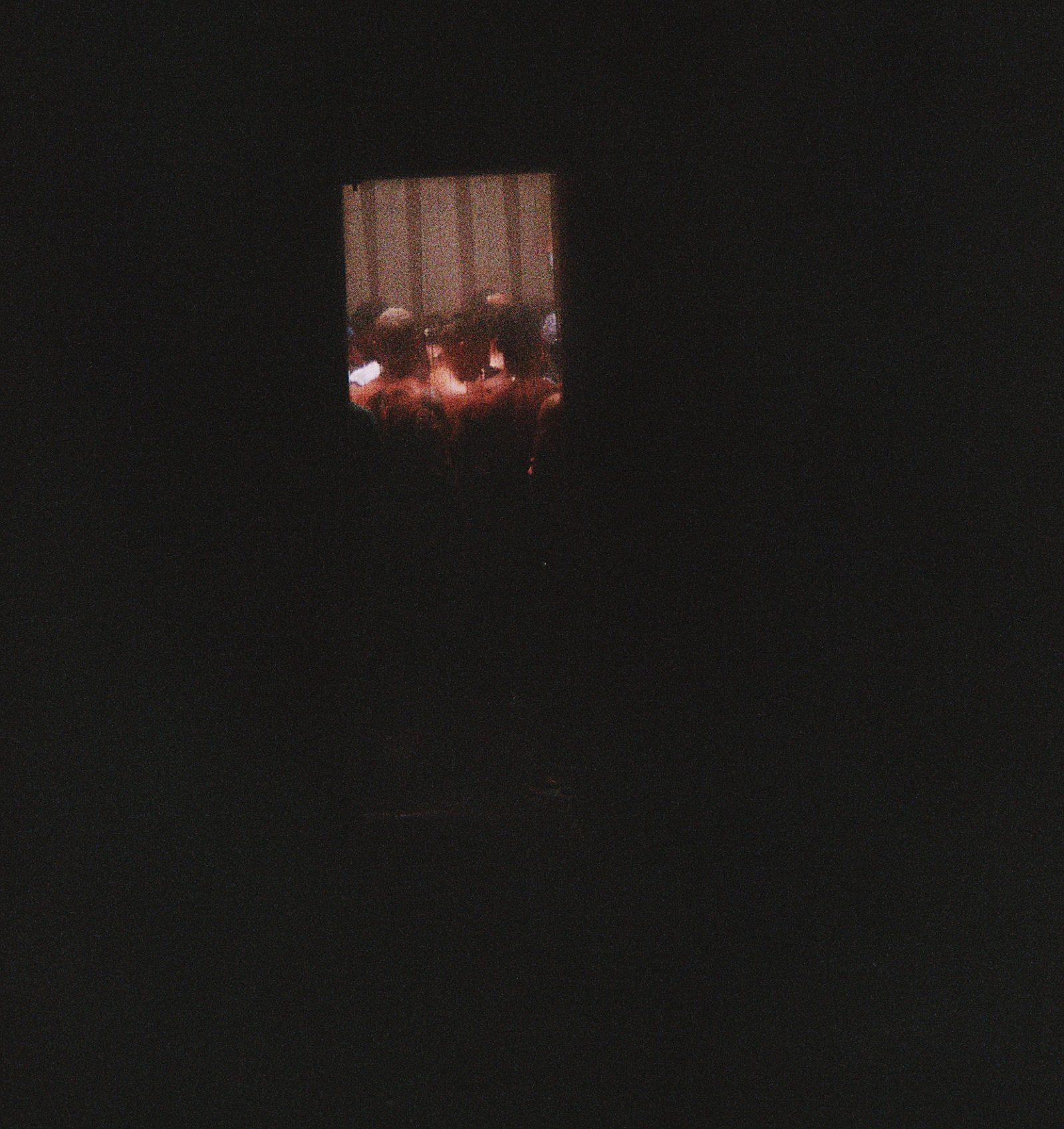 an obscure photo of a darkened doorway at a nightclub.